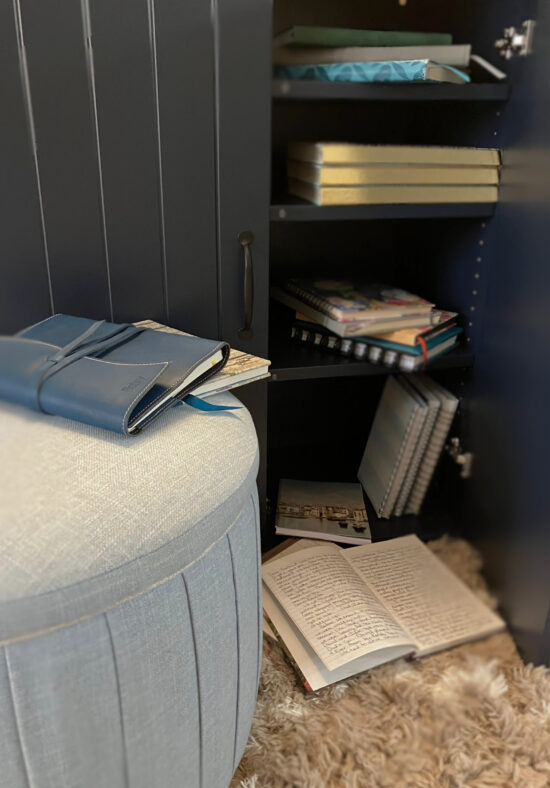 Stacks of my journals spilling out of the cabinet